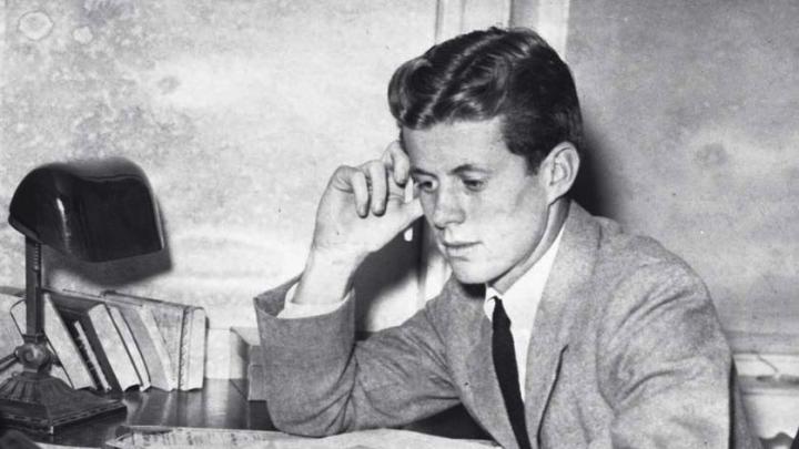 Archival photograph of John F. Kennedy as an undergraduate, circa 1939, studying papers