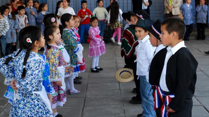 Children perform "cuecas," a Chilean traditional dance, for visitors including Harvard professors who helped design UBC.