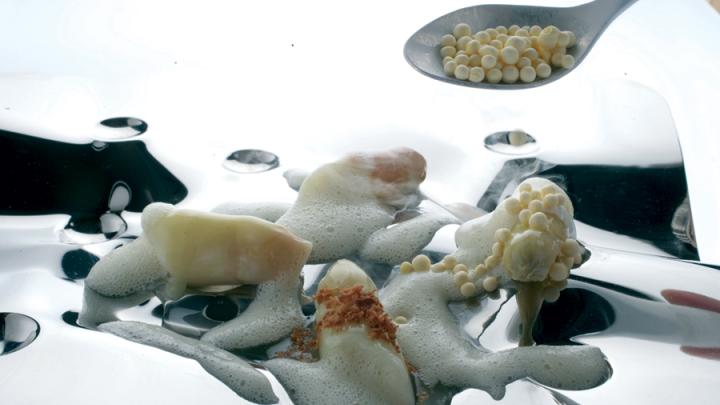 Adrià plays with texture and temperature: "white asparagus, in various temperatures and preparations, with egg-yolk shots"