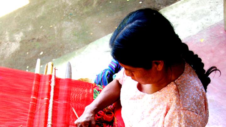 A weaver works on a traditional Mayan back strap loom in Guatemala in 2007. 