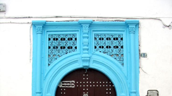 A decorated residential door in the medina in Rabat, Morocco, 2005. The "hand of Fatima" trident at upper left wards off evil and brings luck.