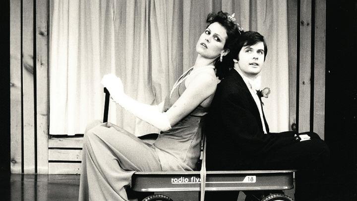 Sigourney Weaver and Durang in their 1979-80 Brecht-Weill cabaret act, <em>Das Lusitania Songspiel</em>. They entered in a red wagon, parodying the opening of the Brecht-Weill opera <em>The Rise and Fall of the City of Mahagonny,</em> in which American capitalists enter in a wagon on a search for gold. 