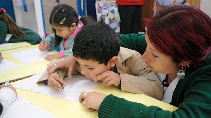 A teacher and student work together on a writing exercise. Chilean schools typically don't begin to teach reading until the first grade; UBC gives teachers strategies for introducing the alphabet and building early literacy with four- and five-year-olds.