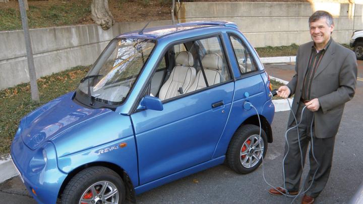 Jeffrey Leonard proudly drives a REVA electric car.