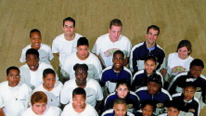 StreetSquash (left) and SquashBusters teams with mentors Polsky and Zaff (back row, second and fourth from left).