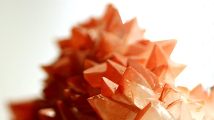 Calcite scalenohedrons (six-sided polyhedrons) with red hematite inclusions from the iron mines of West Cumbria, England 