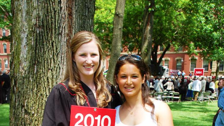 Photograph by Harvard Magazine/VL May 27, 2010 - Cabot House roommates Shawna Sinnott, of Boston, and Michelle Konstadt, of Armonk, New York, were the first members of the newest alumni class to arrive at its designated staging site for the alumni parade.