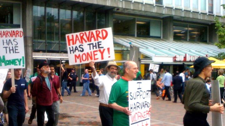 Students and workers protested layoffs on June 25, in a march that began in Harvard Yard and proceeded to Holyoke Center.