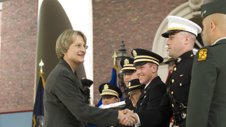 President Drew Faust presented each newly commissioned officer with a copy of <i>Just and Unjust Wars</i> by Michael Walzer.
