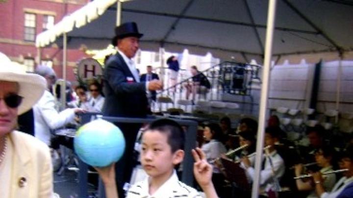Unidentified young man attending 2010 Commencement has the world at his fingertips.