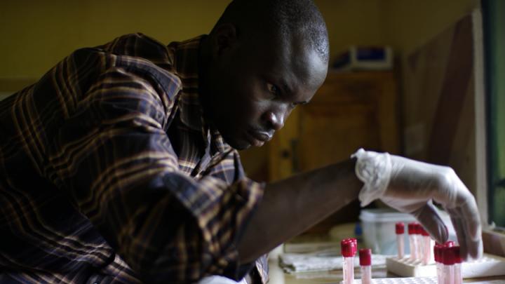 A clinic worker handles blood samples. This clinic offers something unusual for a rural clinic: a staff physician and free, rapid HIV testing each weekday.