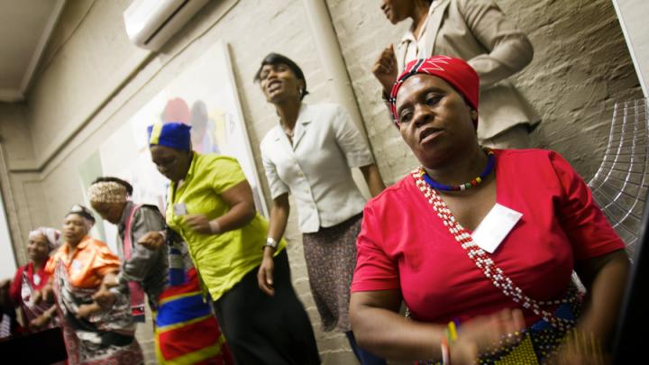 At Edendale Hospital in Pietermaritzburg, South Africa, traditional healers perform a song before telling visitors about their work with iTeach. In the foreground is Makhosi Mbele. (<em>Makhosi</em> is the title used to refer to traditional healers, analogous to "doctor.")