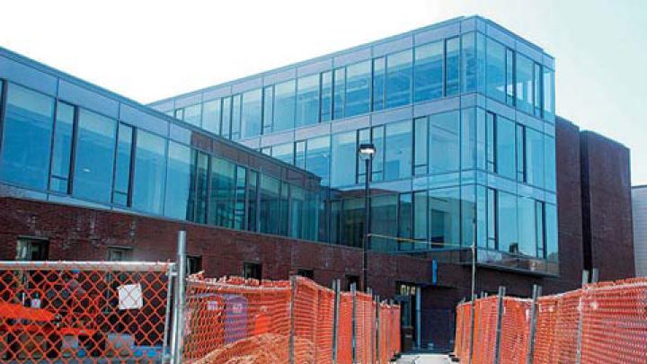 The brick-and-glass Northwest Science Building wends its way among existing structures along Hammond and Oxford streets.