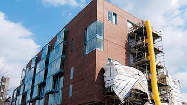 Two views of the Kyu Sung Woo-designed graduate-student housing now rising on Memorial Drive.