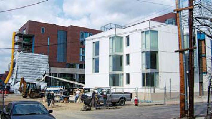 Two views of the Kyu Sung Woo-designed graduate-student housing now rising on Memorial Drive.