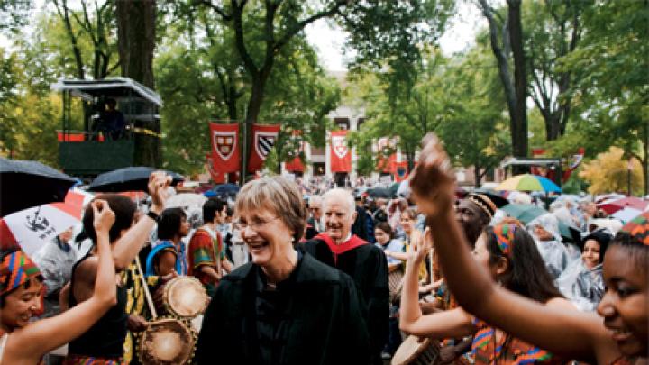 The Harvard College Pan-African Dance and Music Ensemble gives Drew Gilpin Faust, attired in Harvard’s presidential gown, a raucous welcome. President emeritus Derek Bok and James R. Houghton, Senior Fellow of the Harvard Corporation, follow her in the procession into Tercentenary Theatre.