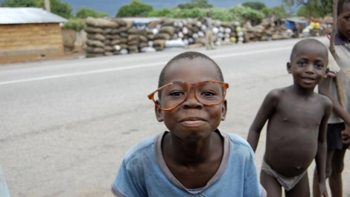 Among the group of children, a comedian mugs for the camera.