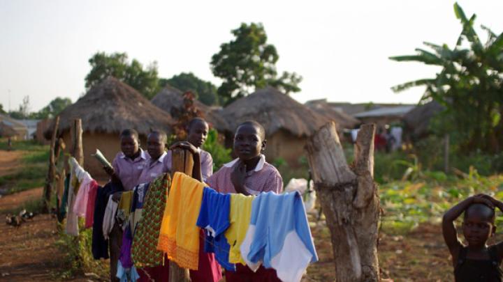 On the orphanage grounds, children hang laundry to dry.