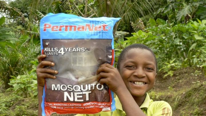 A young (and proud) recipient of a GMin mosquito net