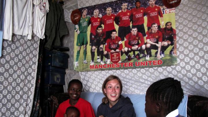 Nowak visits Obado's home. At left are Obado's son Carlos, and her sister.