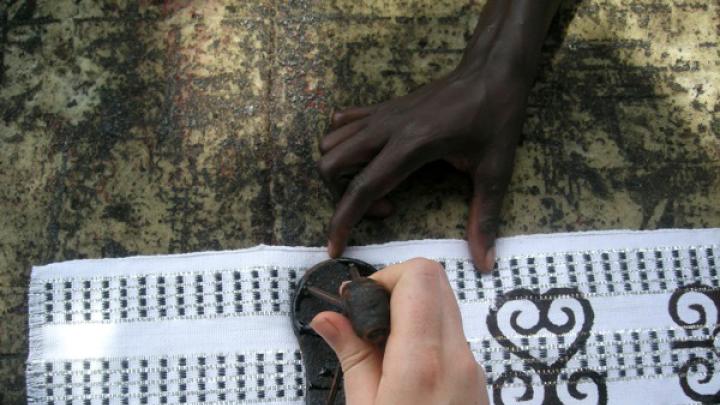 Stamping a piece of kente cloth with Adinkra symbols in Ntonso. Although Adinkra is sometimes cast as a closed system of symbols passed down through history, Ryan learned that the system is rather “something fluid that’s constantly in the making,” she says. “New symbols are being created every day. They’re not considered not to be Adinkra just because they’re being created now.”