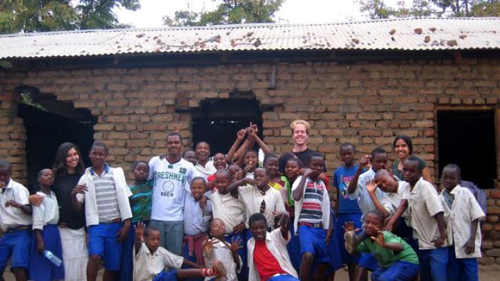 Jasrasaria first visited Arusha as a volunteer for Support for International Change (SIC), a U.S.-based NGO that conducts HIV education, counseling, and testing. Here, Jasrasaria (back row, right) poses with American volunteers, Tanzanian teaching partners, and children who took part in an afterschool “Fight HIV/AIDS Club” the SIC volunteers led.