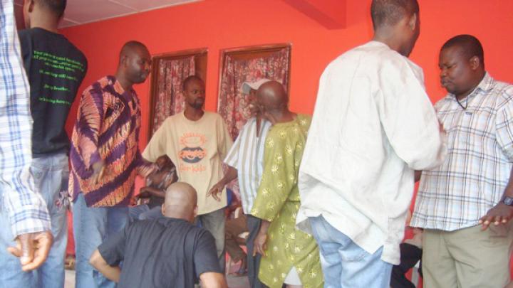 Discussing the water project in 2008 at a community-wide meeting with the Saahene (chief warrior of the village), village elders, a youth representative from the village, district government officials, and a local nongovernmental organization (NGO).