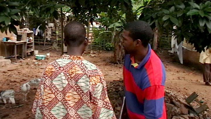 Sangu Delle and Darryl Finkton conducting household visits to test drinking water, deliver information about clean water and sanitation, and let residents know about Project ACWA’s household latrine program.