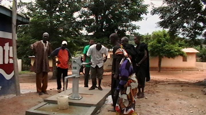 Testing the borehole with the village chief, elders, the engineer, and members of the Harvard team