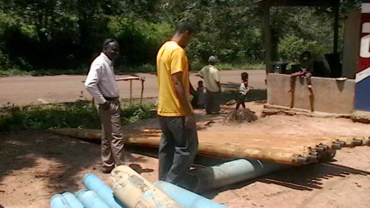 Darryl Finkton inspects the materials used in constructing the borehole.