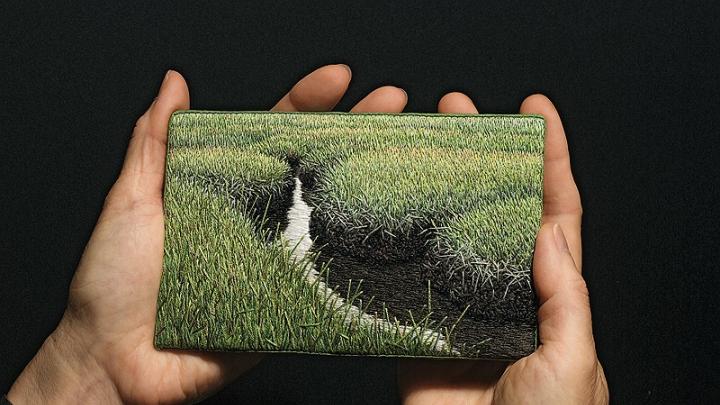 The artist holds <i>Summer Salt Marsh</i> (2008).