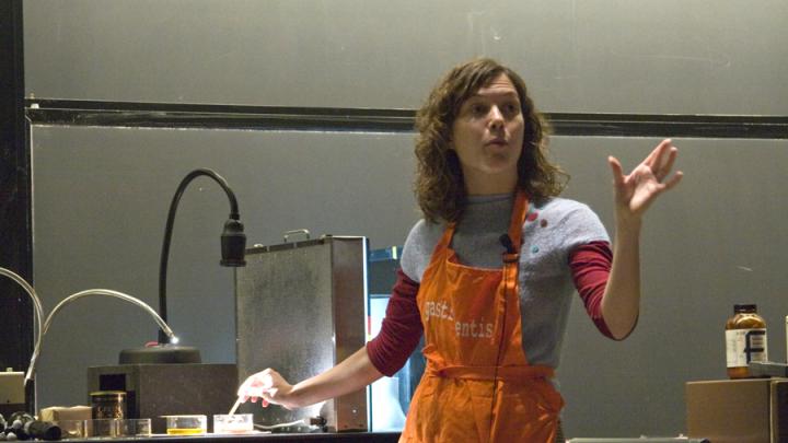 Amy Rowat stirs cocoa powder into cocoa butter to show that the two substances don't blend easily.