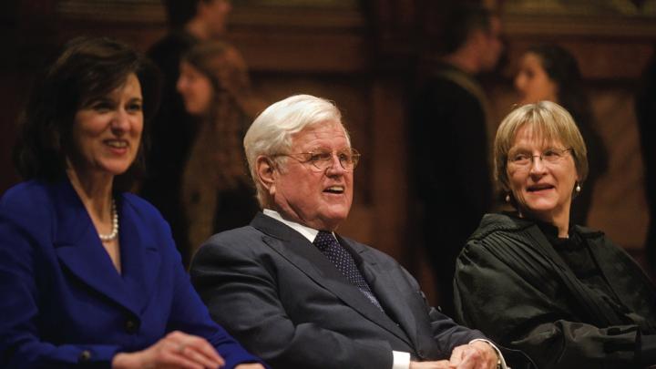 Senator Edward M. Kennedy, his wife, Victoria Reggie Kennedy, and President Drew Faust. Members of the Kuumba Singers appear in the rear.