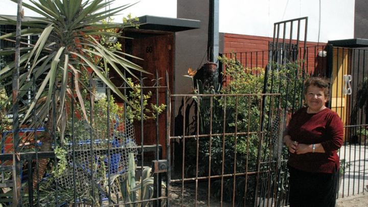 ...she has fenced in her front yard and filled it with plants, which she sells as her livelihood. And Ortega says this home, though unfinished, is a big improvement over her former makeshift home in the shantytown.