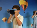 Boy and girl uses VR goggles