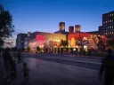Rendering of the Center for Creativity and Performance with a new residential building rising behind it.