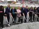 Photograph of stakeholders tossing the first ceremonial shovel of dirt at the groundbreaking on the ERC site in Allston