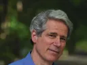 Greg Stone poses in front of trees