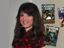 A smiling woman with brown hair next to three book covers
