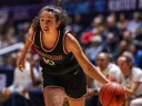 Elena Rodriguez dribbling the basketball up the court 