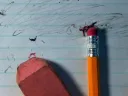 pencils and eraser fragments over an erased piece of paper