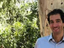 Daniel Mason posing with a tree