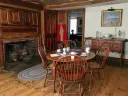 Kitchen at Whittier Birthplace with round wood table and 4 chairs and wood surround fireplace