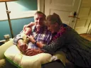 Photo of the Hrdys, author and husband, with their first grandchild