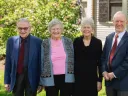 group of four people standing outside 