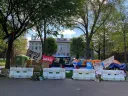 Encampment in Harvard Yard, with signs and tents
