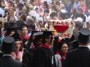 Protestors walking out of Harvard Commencement 