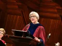 Drew Gilpin Faust in robes at the podium in Sanders Theater