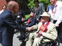 President Alan Garber greets Bertram A. “Bert” Huberman ’44  and George Post ’45