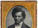 Oval black and white image of Frederick Douglas with gold frame around image